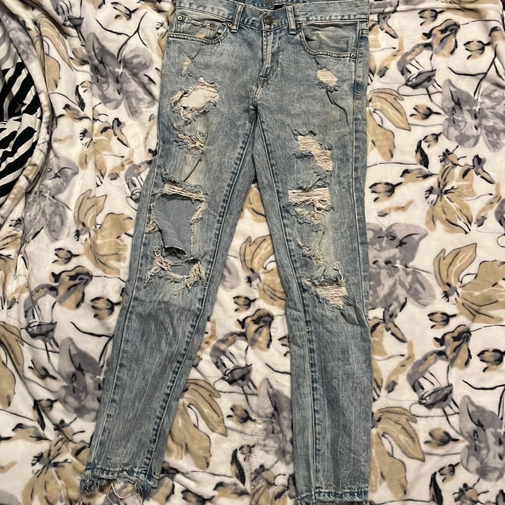 mens jeans. low waisted have quite a few holes.